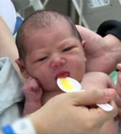 Mother spoon feeding her baby | Doylestown Health